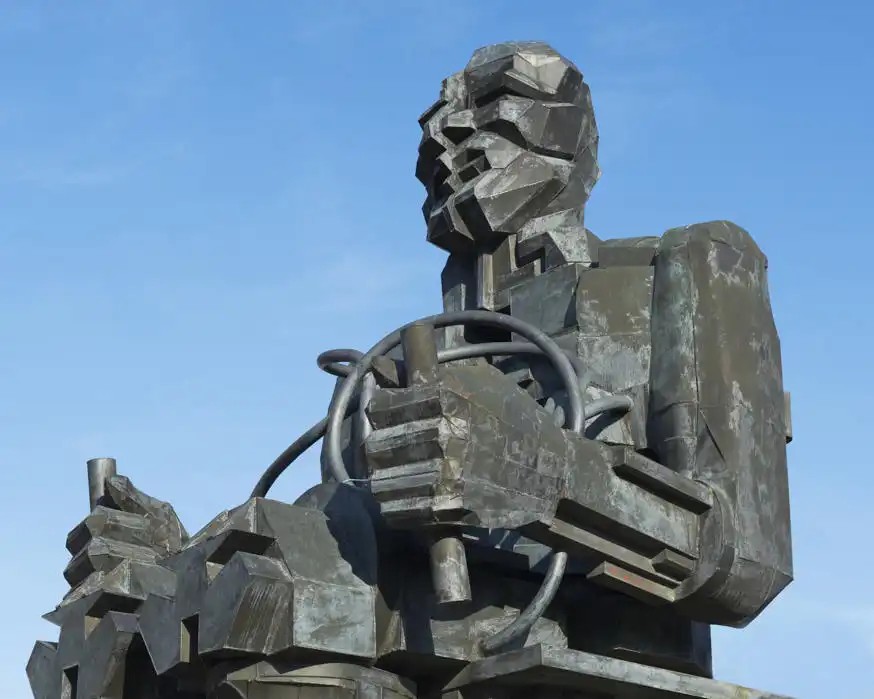 Iron statue of Faraday set against a blue sky